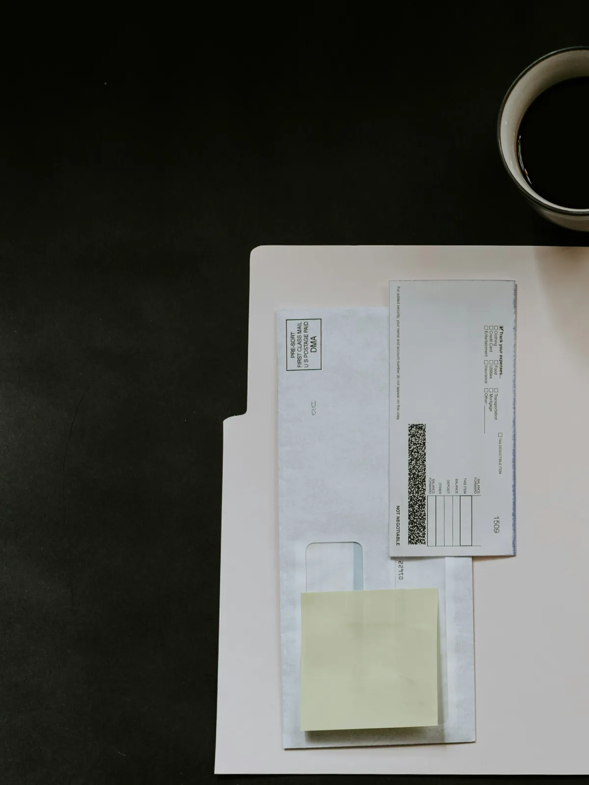 A folder of paperwork and a cup of coffee on the table