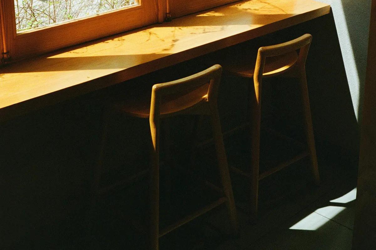 Two chairs at a sunlit window, where clients actually sit