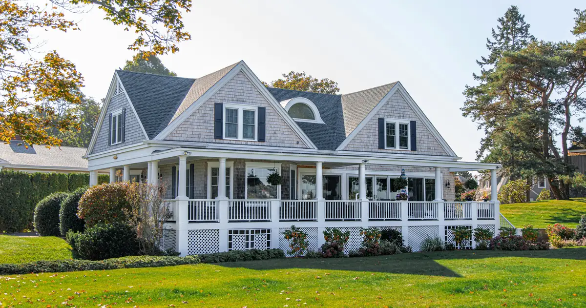 A shingle-style home with a wraparound porch, the 88 Juniper Bend listing